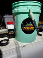 Green container with a 'Dead Bait Solutions' label on a metallic surface.